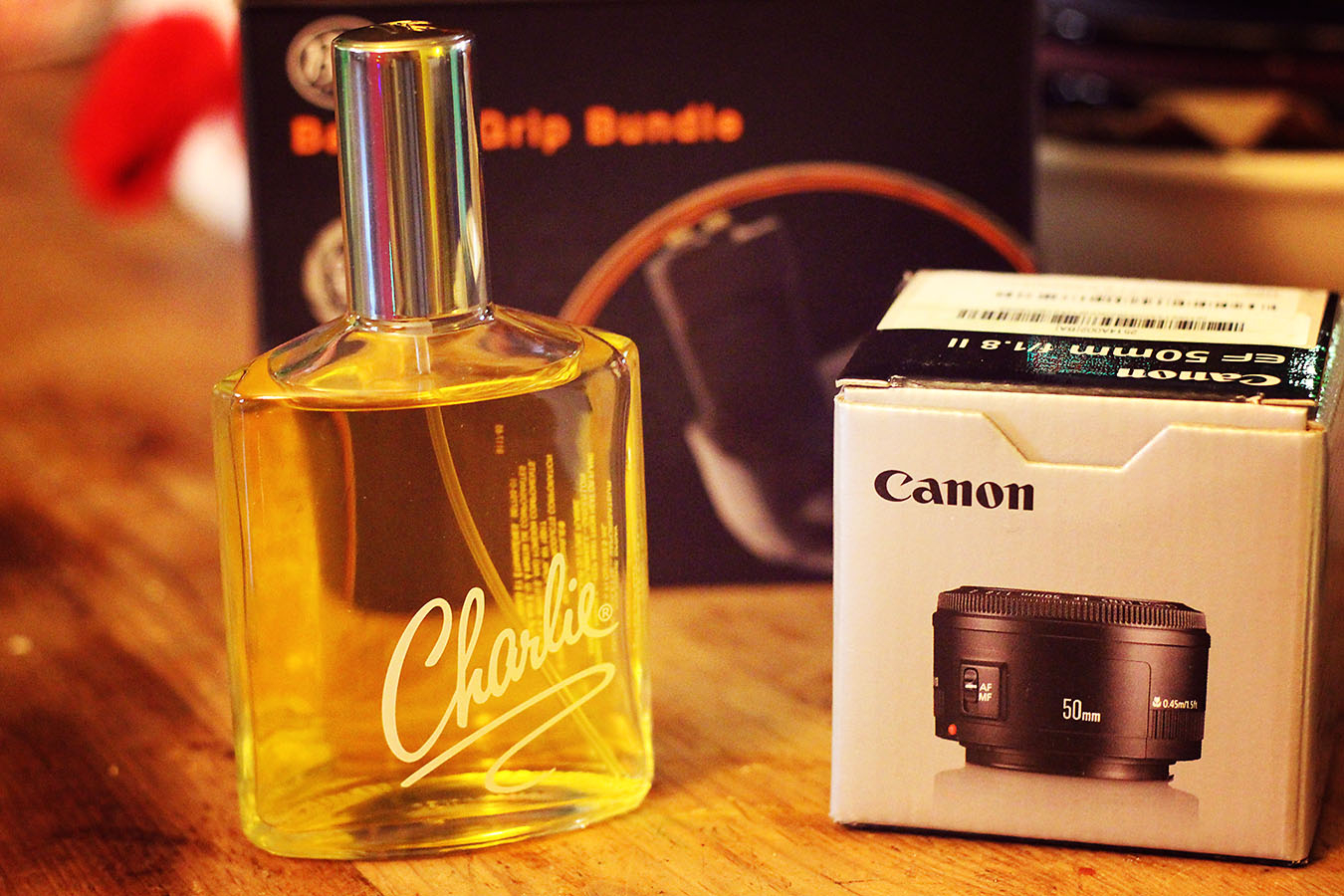 From my eldest daughter, one of my favorite perfumes; from my honey, a sweet little 50mm lens and an extended battery grip for my camera.