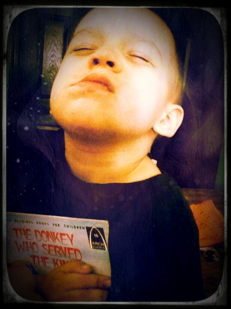 Earlier today I was reading to him, and he kept giving me book after book, couldn't decide which one he wanted.  I asked him to smile with his book, and he gave me his special "smolder"! Lol -- he's such a funny kiddo!