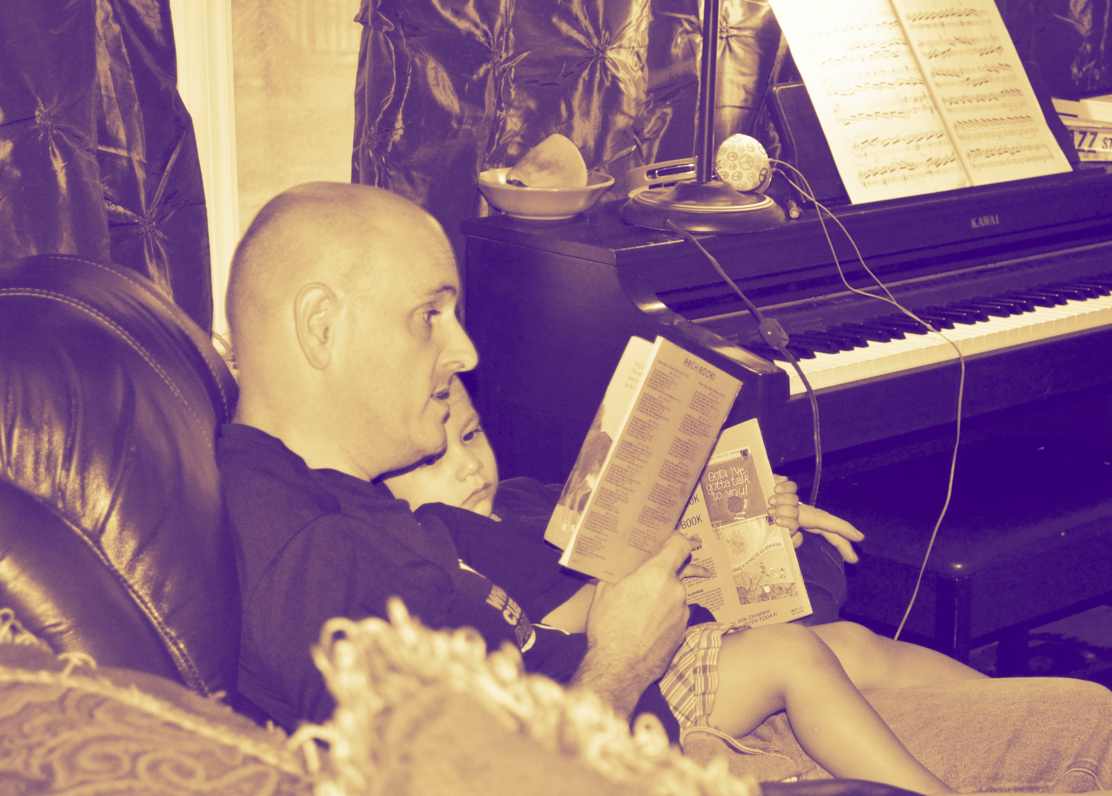 Here he is listening attentively to a story about the nativity, with another book at the ready.